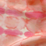 Detail of the peach, coral and pink tye dye silk scarf.